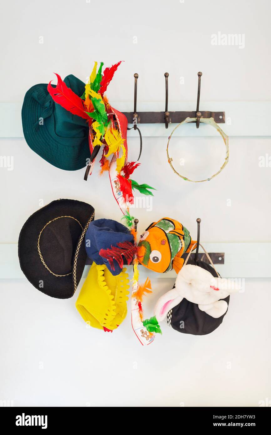 Toys and hats hanging from hook in kindergarten Stock Photo