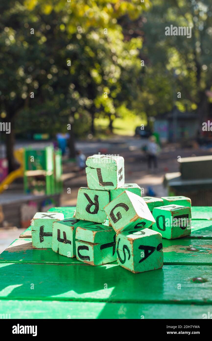 Green wooden blocks on table outside kindergarten Stock Photo