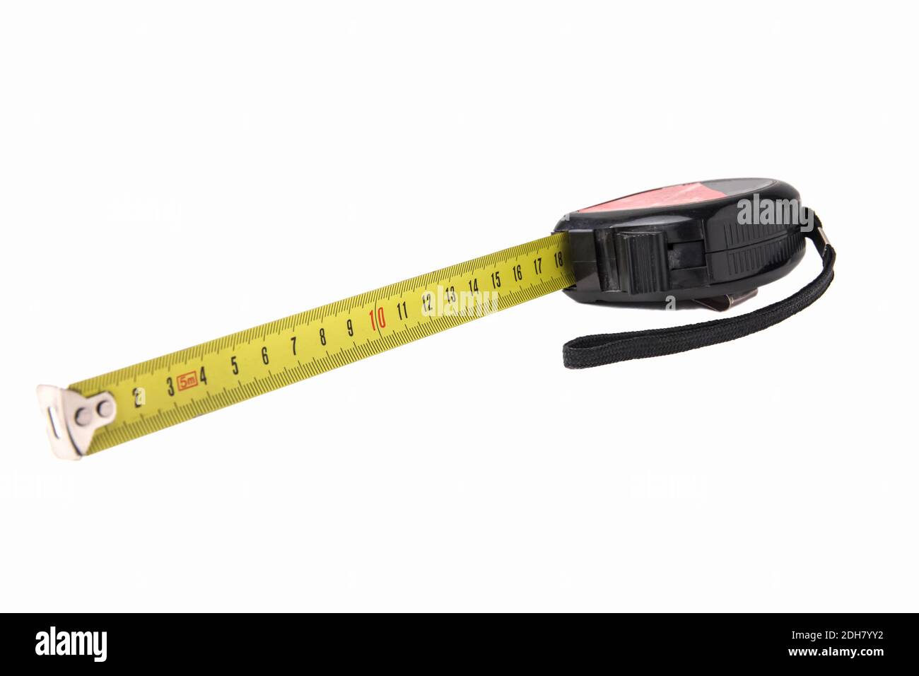 Construction tape measure in black, lying on its side with an open tape. Isolated on a white background Stock Photo