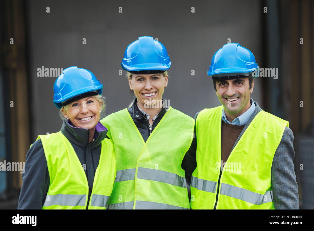 Portrait of confident workers in protective clothing at factory Stock Photo