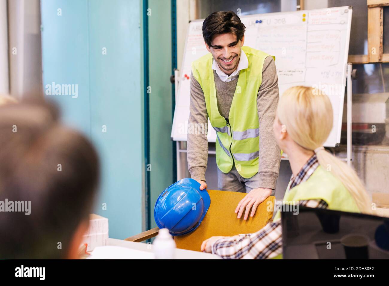 Manual workers conversing in factory Stock Photo