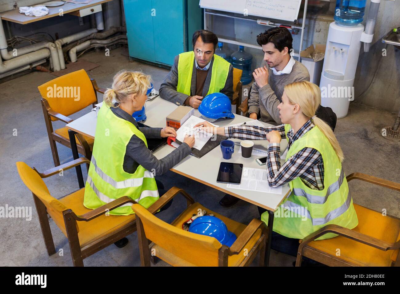 Manual workers planning at table in factory Stock Photo Alamy