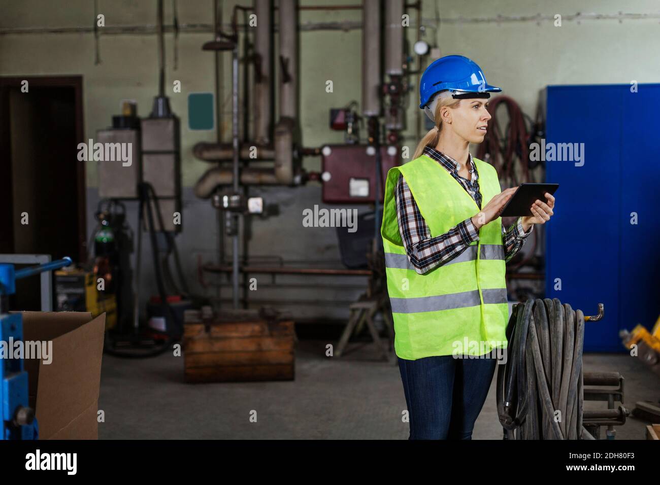 Female manual worker using digital tablet in factory Stock Photo