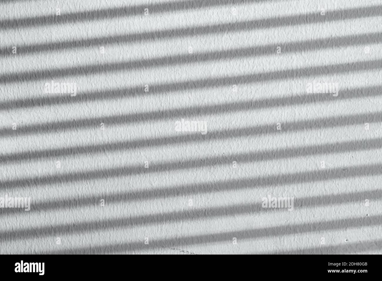 Shadow on a white striped wall. Natural background from blinds. High quality photo Stock Photo