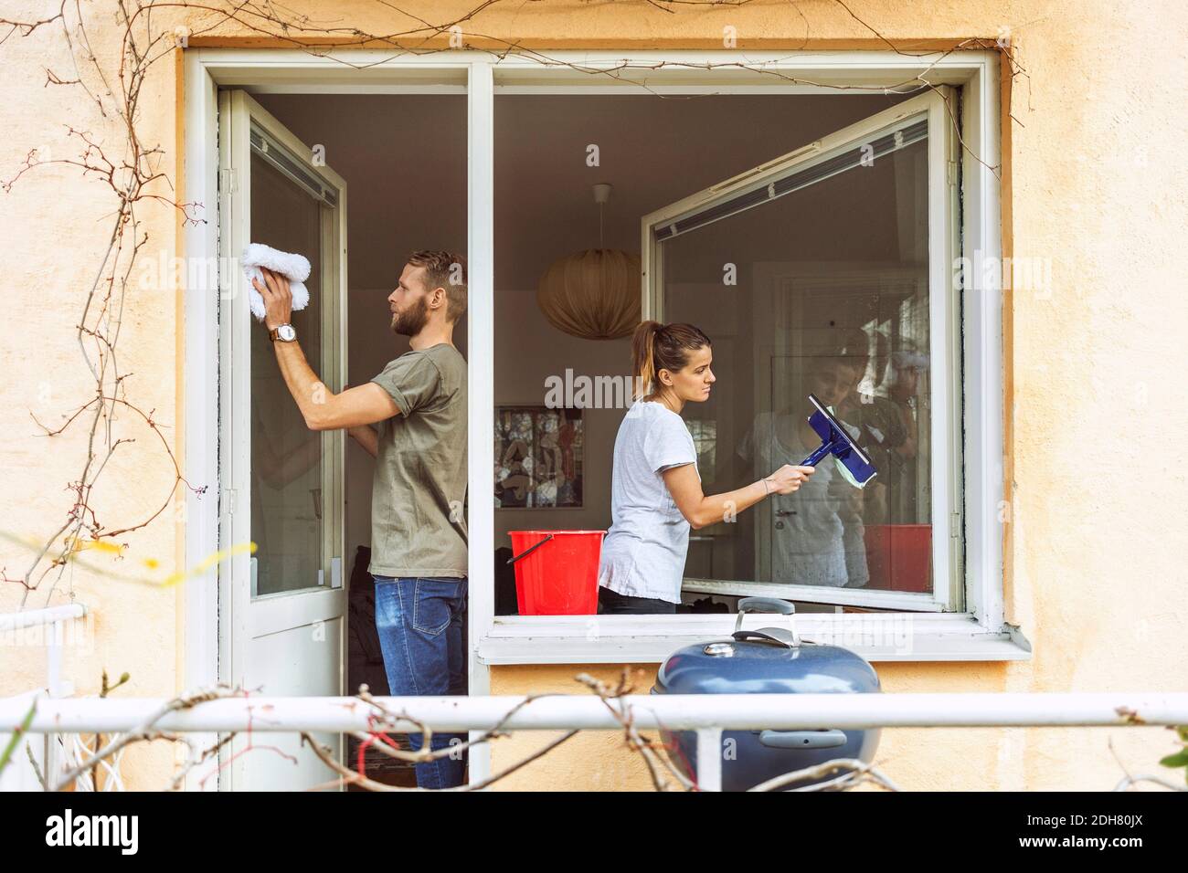 Woman and man cleaning window together Stock Photo