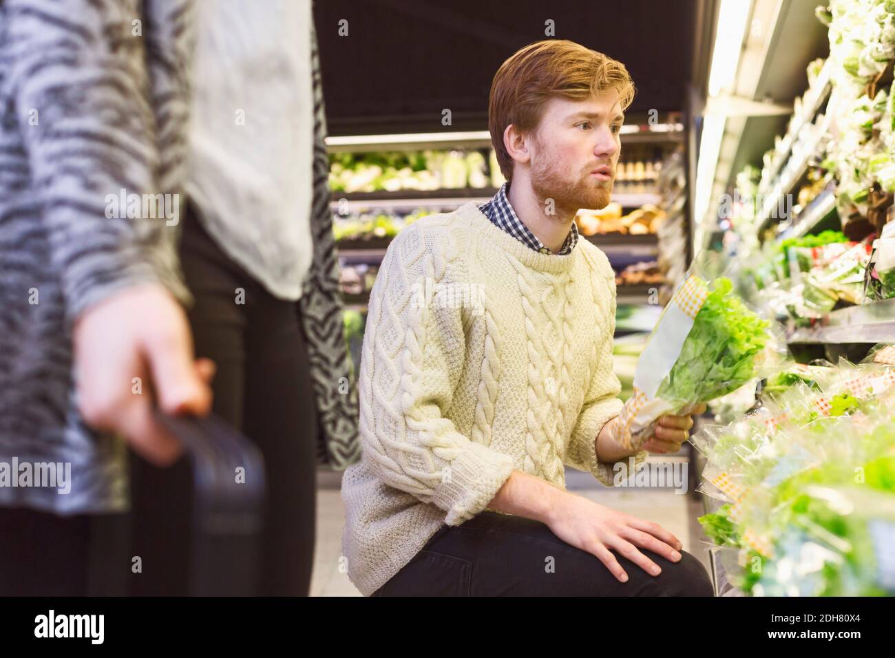 Man shopping lettuce at supermarket Stock Photo