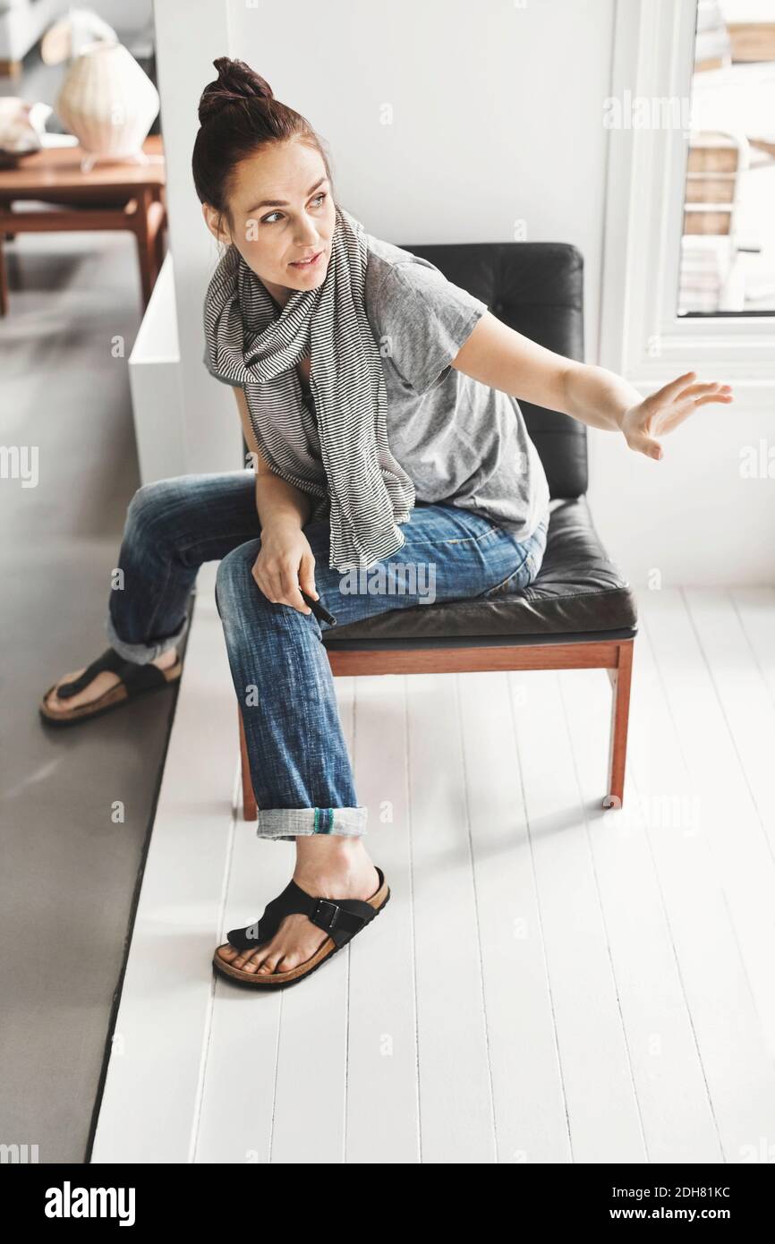 Woman sitting on office chair hi-res stock photography and images - Alamy