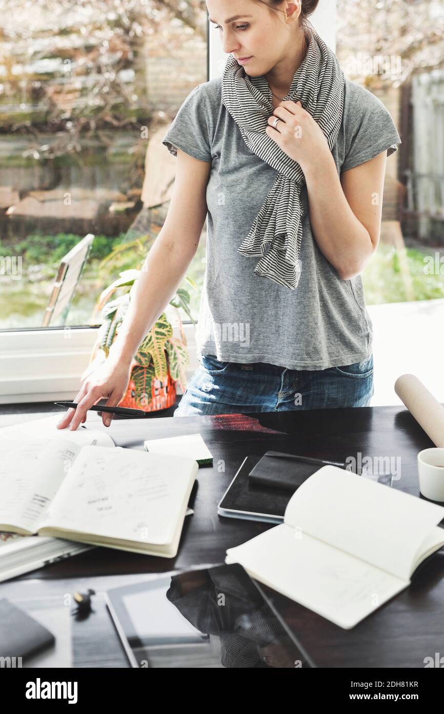 Female architect working at table in office Stock Photo