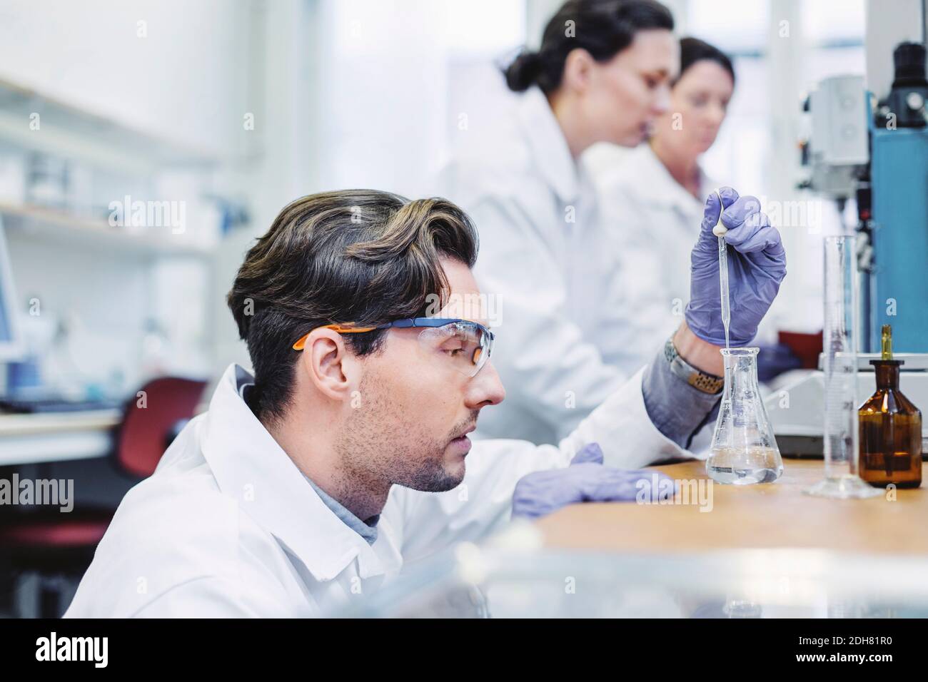 Scientist holding flask sample hi-res stock photography and images - Alamy
