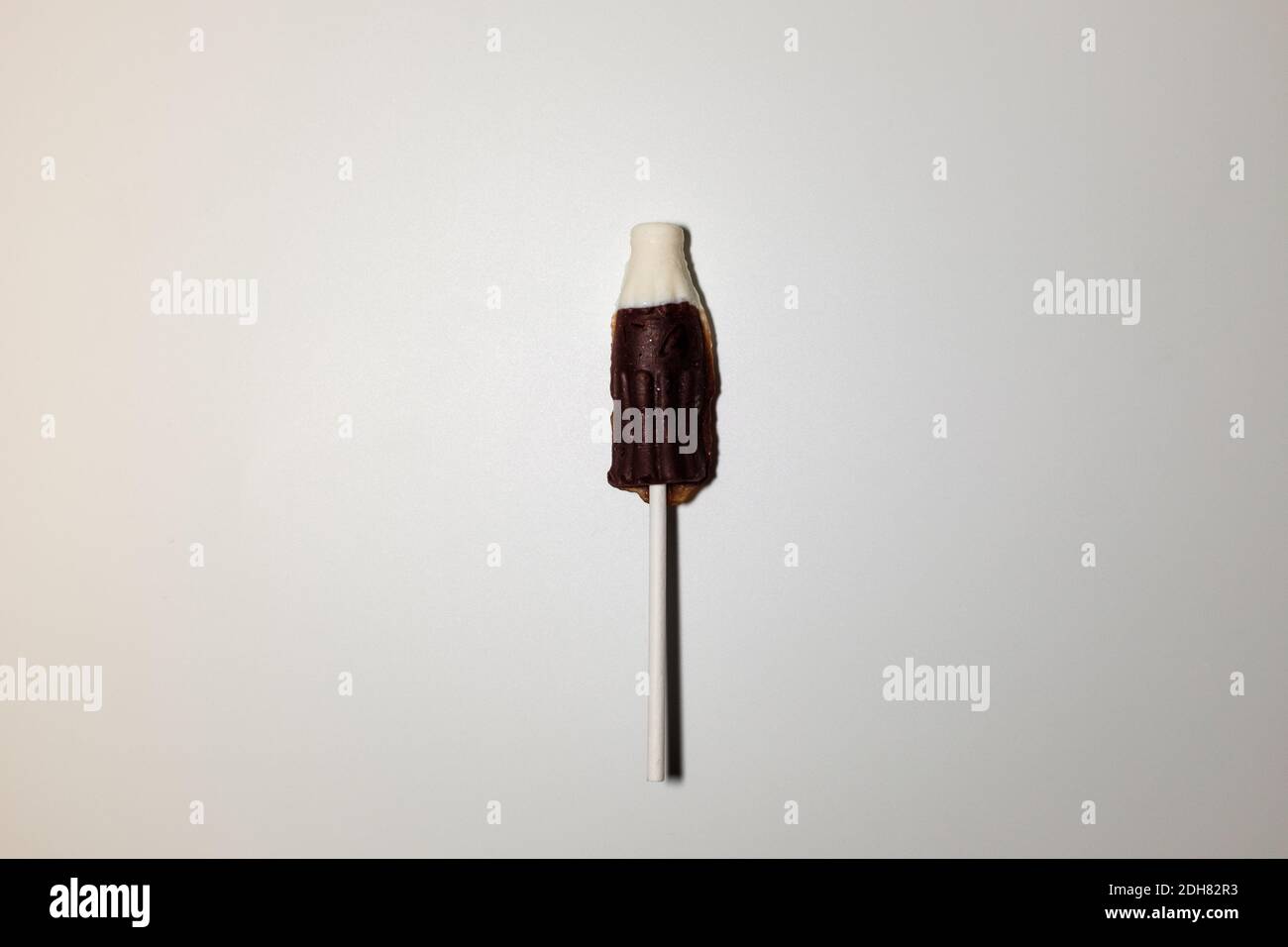 Coke bottle-shaped cola flavored lollipops Stock Photo