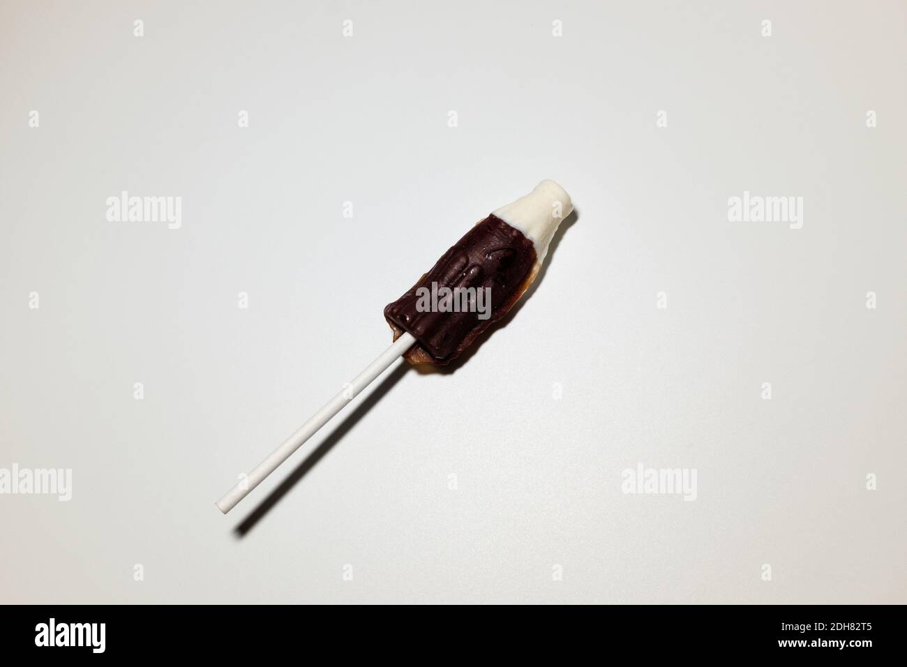 Coke bottleshaped cola flavored lollipops Stock Photo Alamy