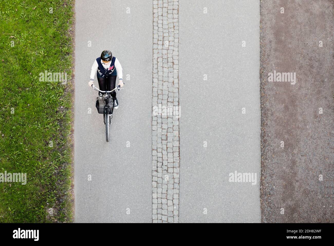 High angle view of businesswoman riding bicycle on road Stock Photo