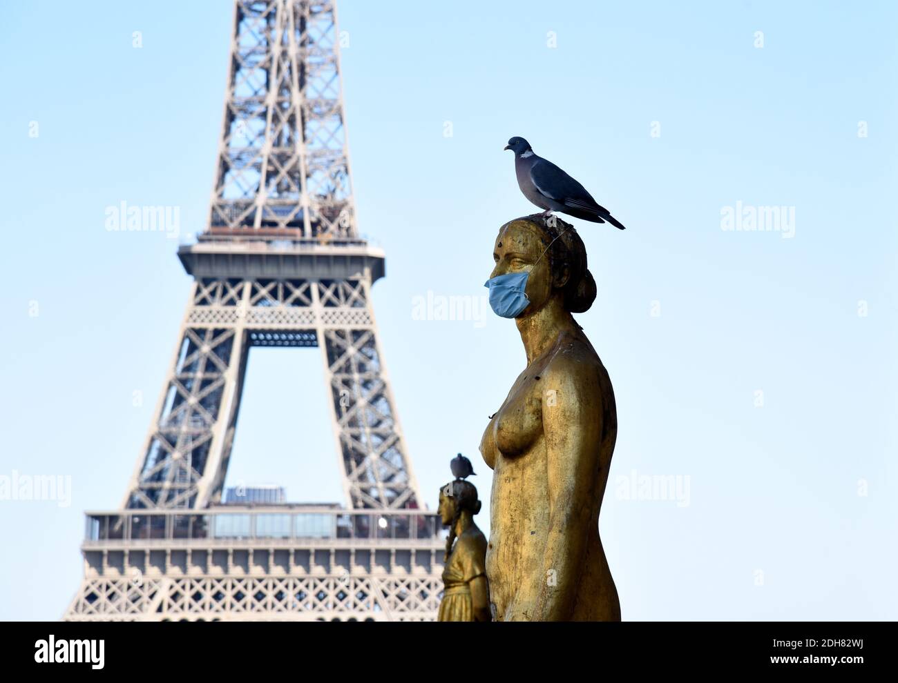 Paris (France) on May 17, 2020: statue in 'Place du Trocadero' square with a protective mask against Coronavirus, Covid19, and the Eiffel Tower in the Stock Photo
