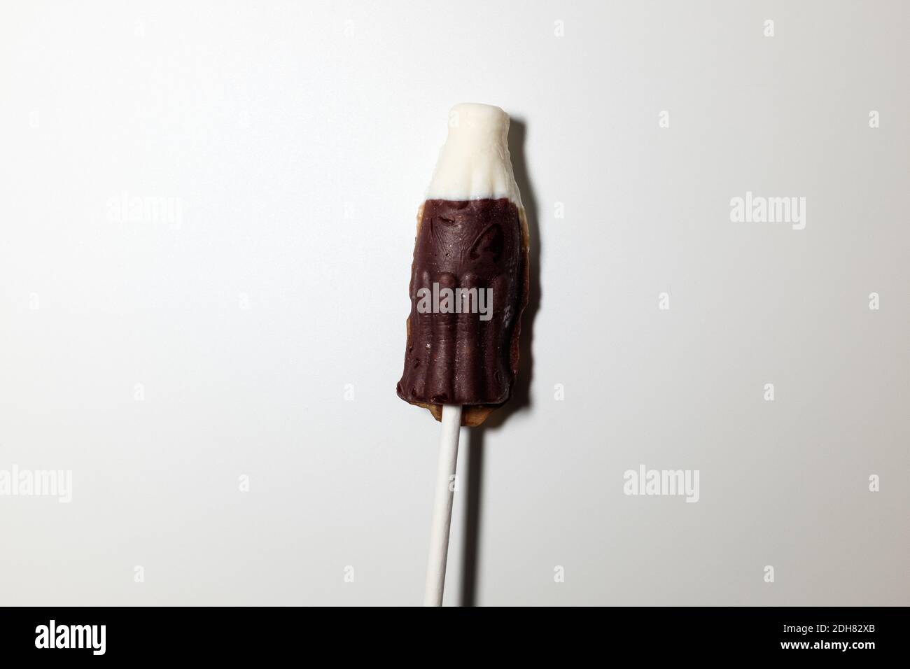 Coke bottle-shaped cola flavored lollipops Stock Photo