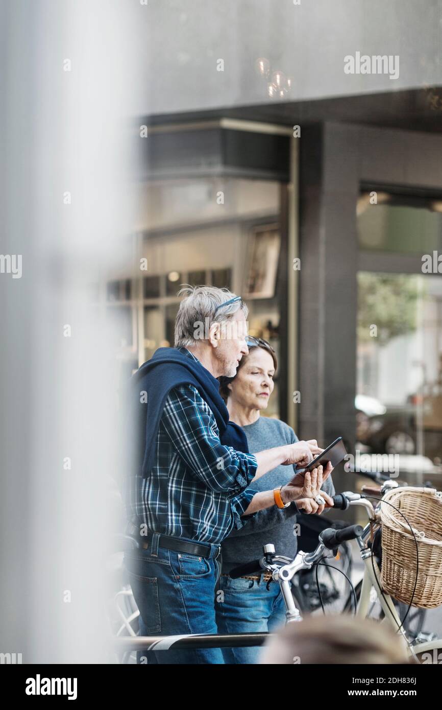 Senior couple using digital tablet outdoors Stock Photo