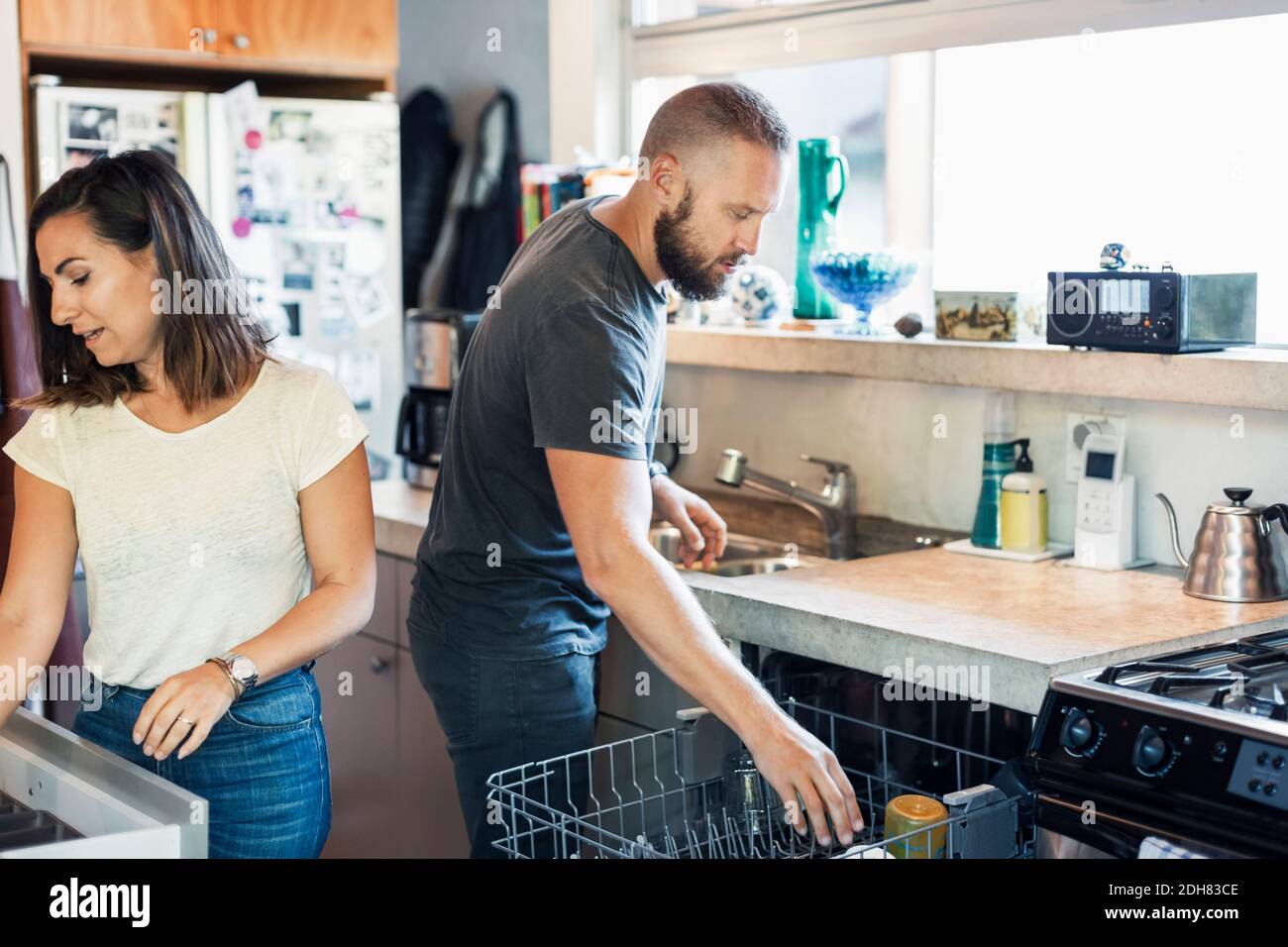 Couple working together in kitchen Stock Photo