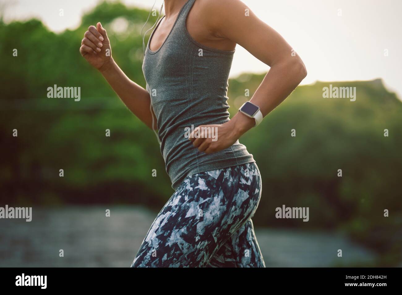 Midsection of woman running at park Stock Photo