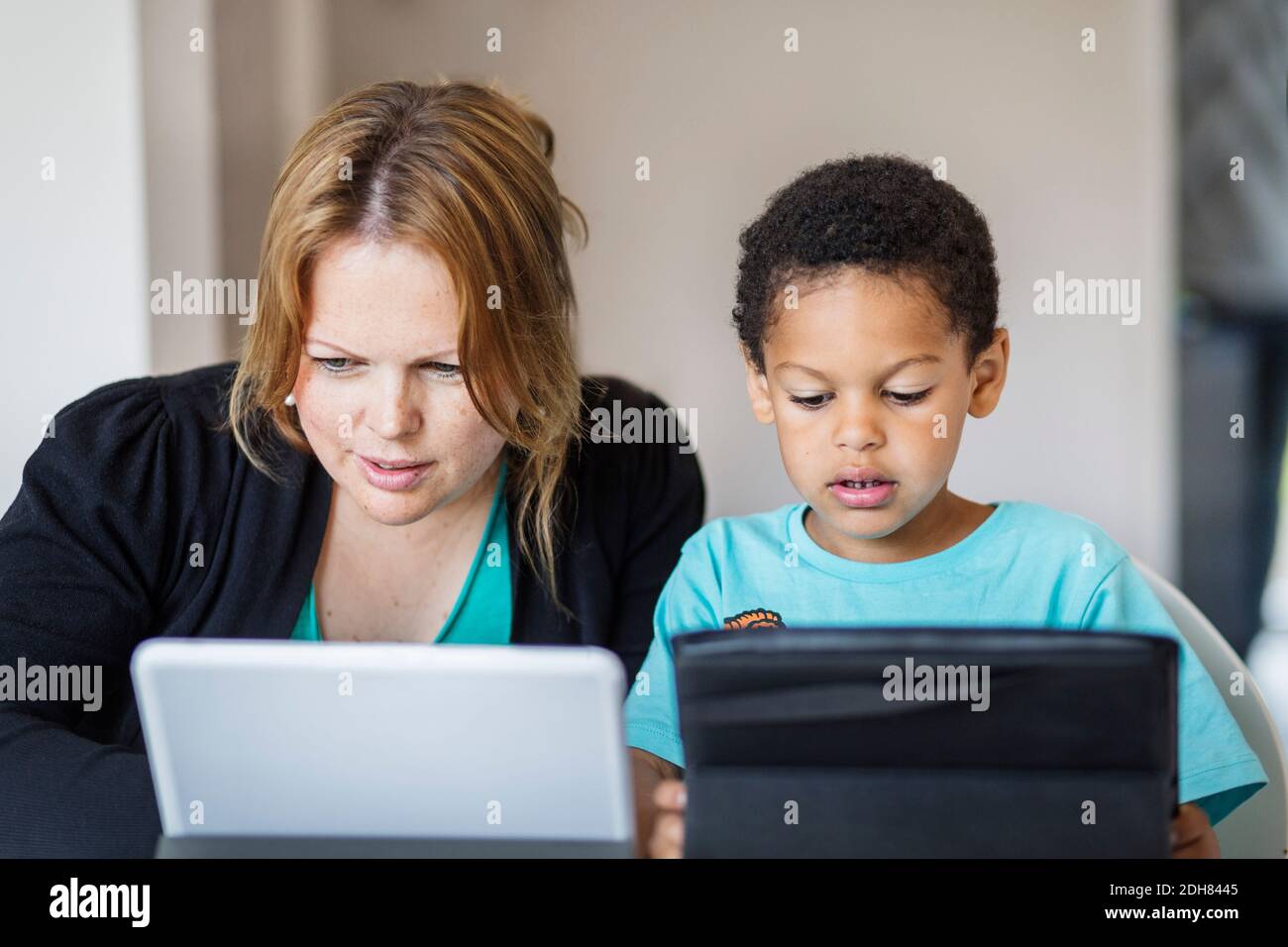 Mother and son using digital tablets at home Stock Photo