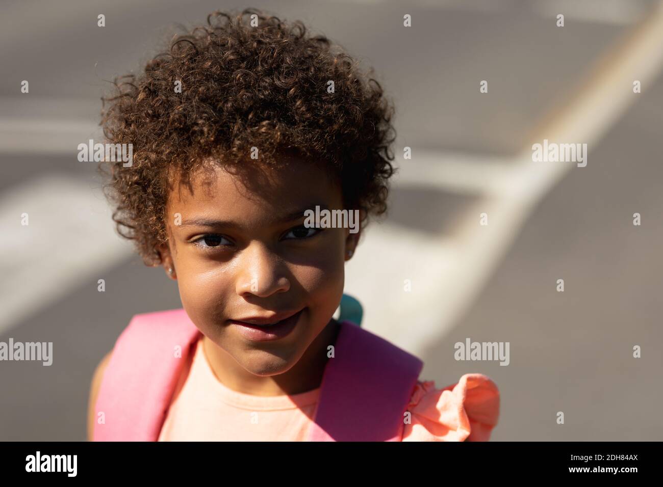 Schoolgirl smiling to camera near a pedestrian crossing Stock Photo - Alamy