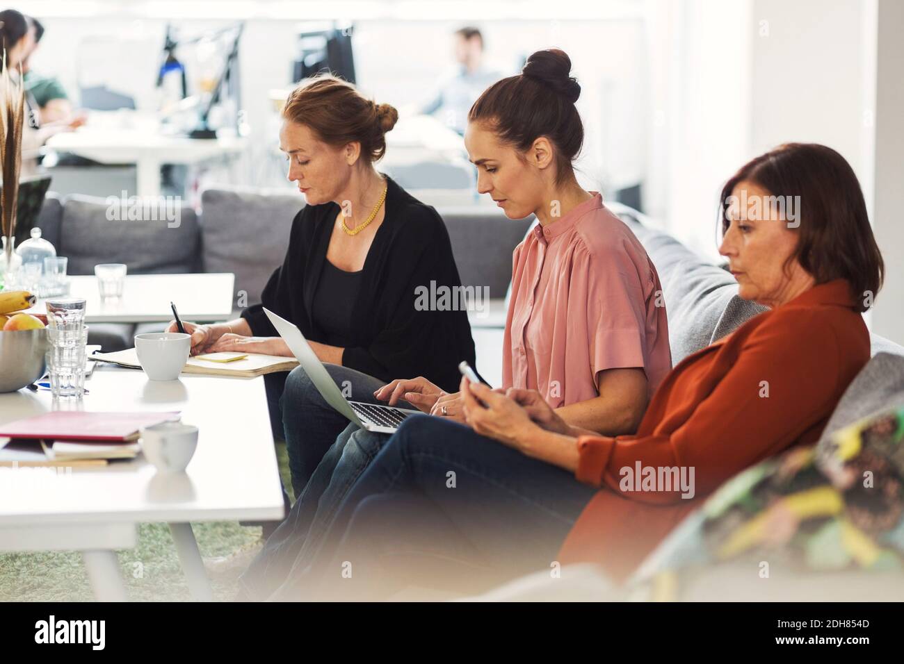 Businesswomen working together in office lobby Stock Photo - Alamy