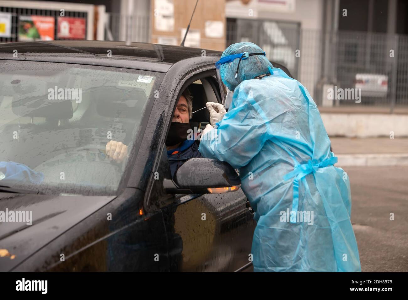 Thessaloniki, Greece - December 10, 2020. A medical worker wearing special suit to protect against coronavirus, conduct a "drive through" rapid testin Stock Photo