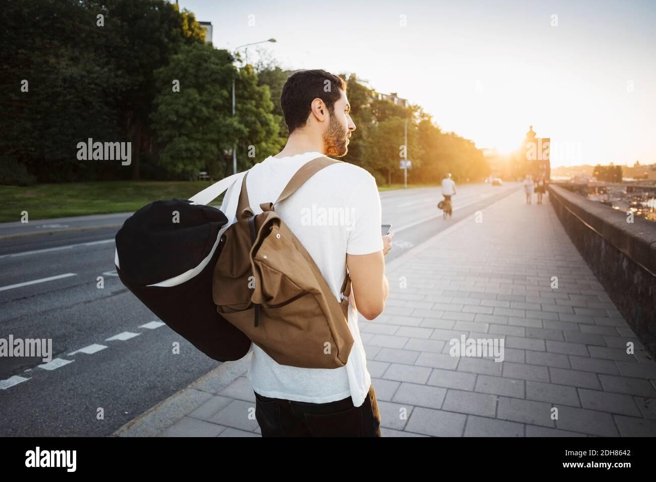 Back view male tourist walking hi-res stock photography and images - Alamy