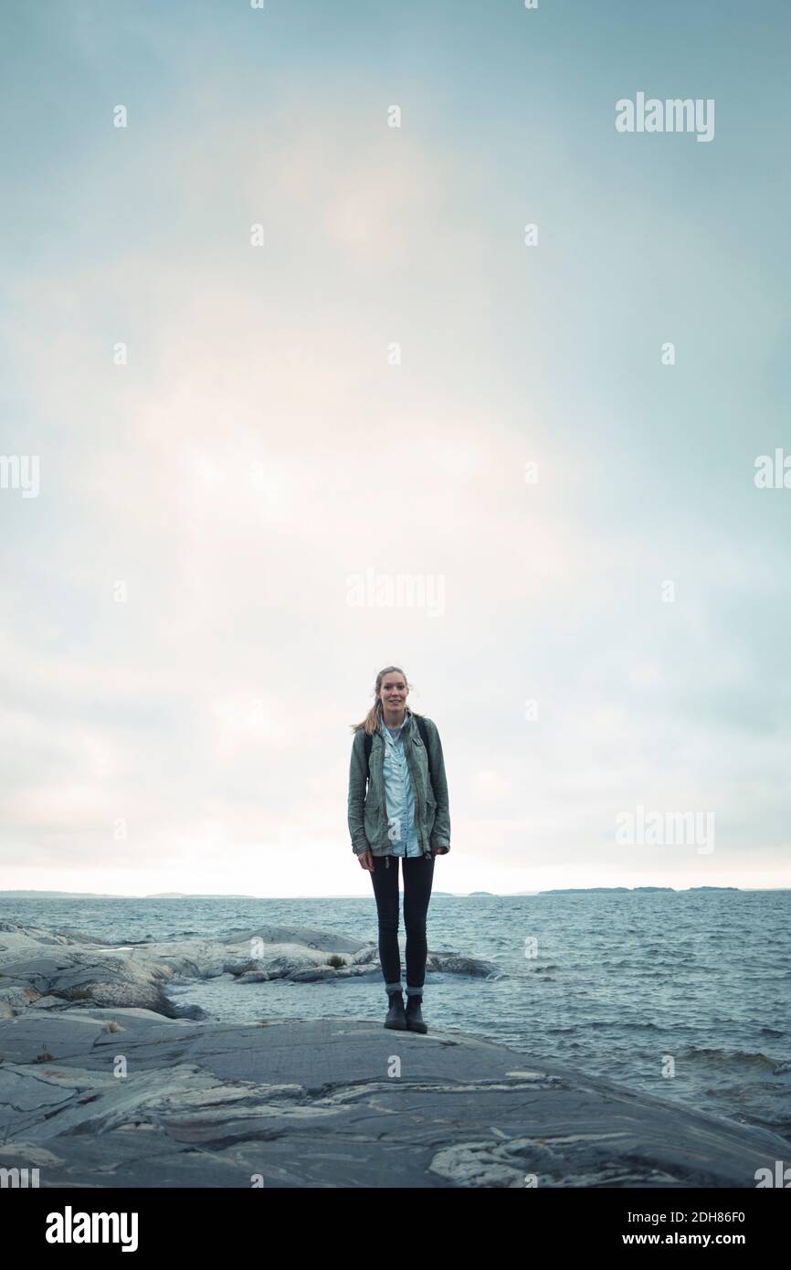 Woman standing in front of sea hi-res stock photography and images - Alamy