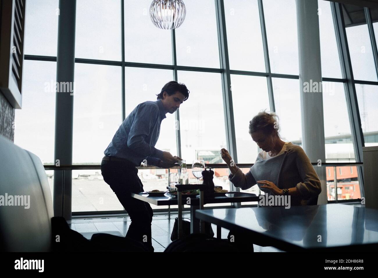 Businesspeople at cafe in airport Stock Photo