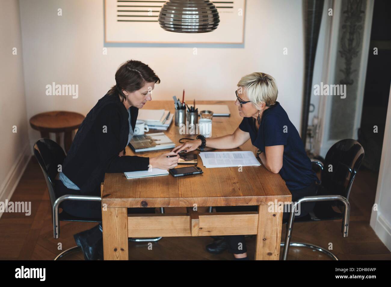 Female industrial designers using digital tablet at home office Stock Photo