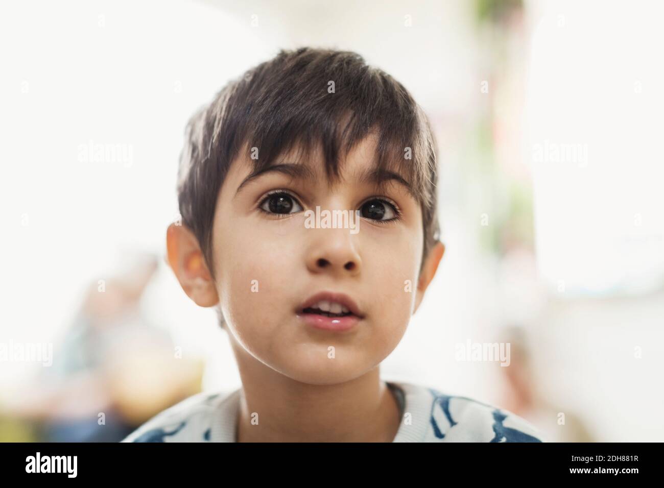 Boy looking away in day care center Stock Photo