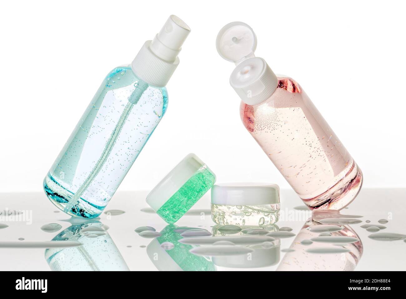 assorted toiletries and water droplets on white background Stock Photo
