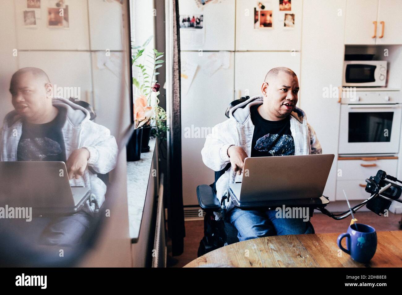 Disabled man with laptop in recording studio Stock Photo Alamy