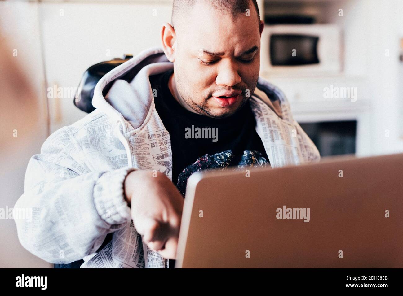 Disabled man using laptop in recording studio Stock Photo Alamy