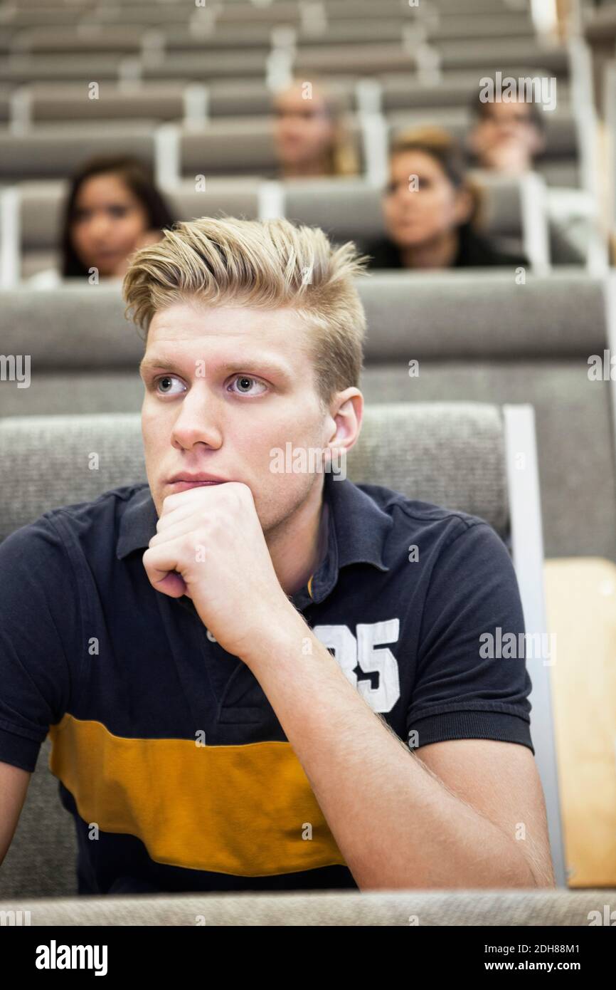 Close up of handsome young man concentrating on seminar Stock Photo