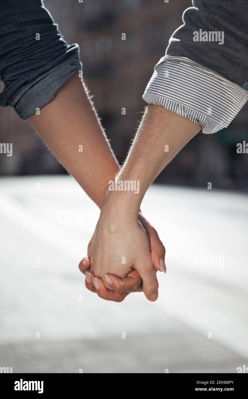 Close up of man and woman holding hands Stock Photo