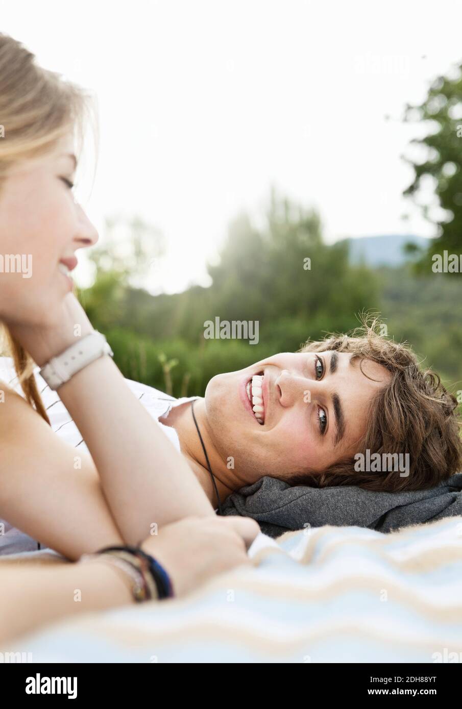 Portrait of handsome young man while woman in front looking Stock Photo