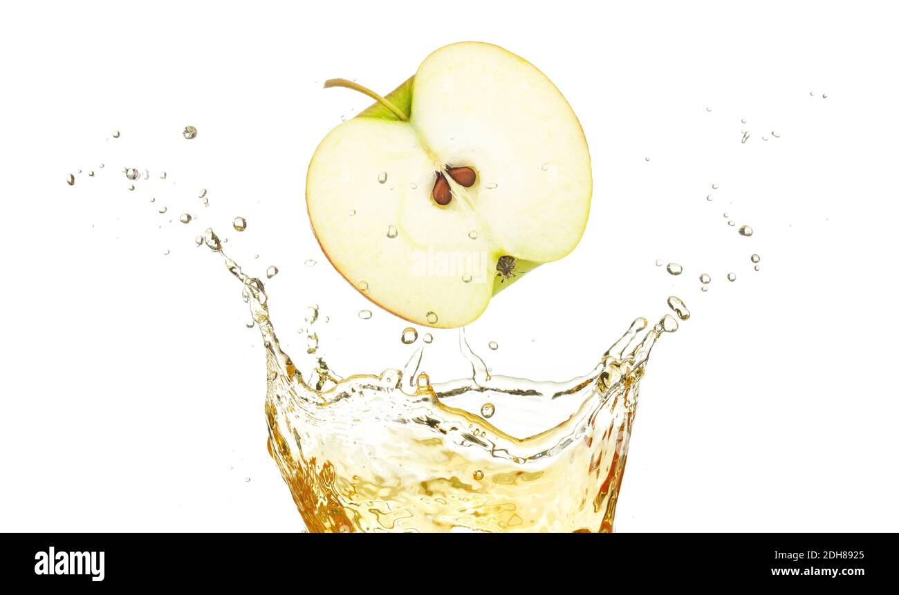 half apple falling in splashing juice isolated on white Stock Photo