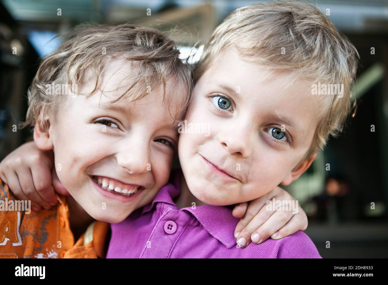 Portrait of a two playful brothers with arms around Stock Photo