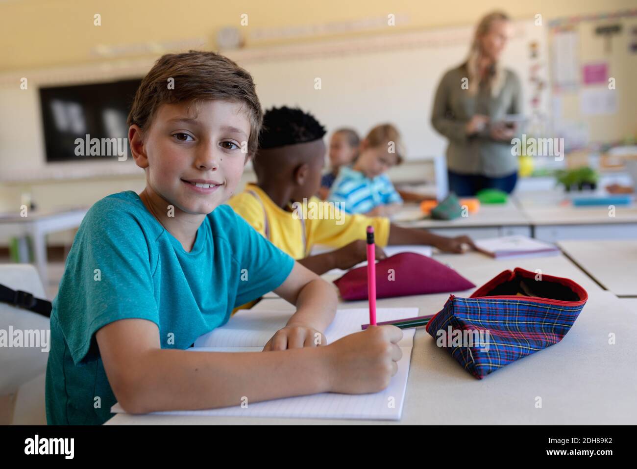 Schoolboy sitting at a desk in an elementary school classroom Stock ...