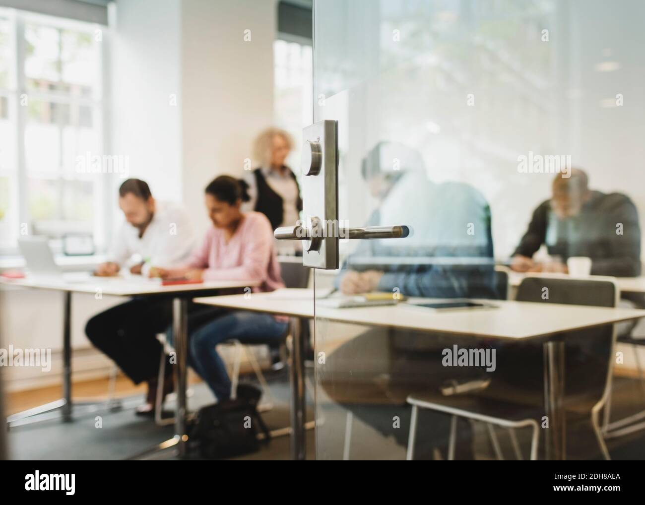 Teacher and students in language class seen through open door Stock Photo