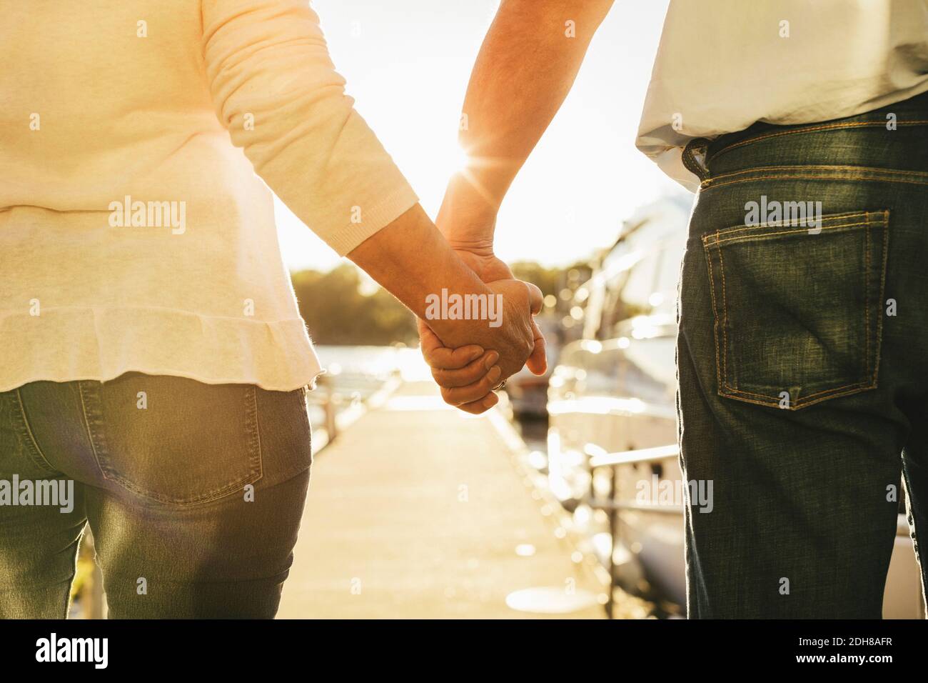 Back view couple holding hands hi-res stock photography and images - Alamy