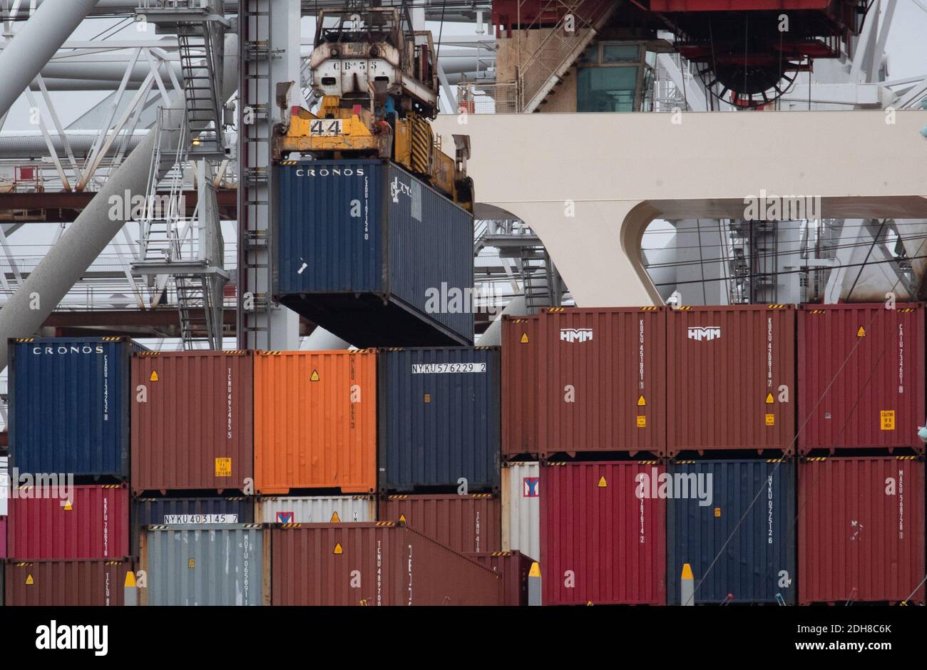 Containers are unloaded from the container ship MOL Treasure whilst at berth at DP World container terminal in Southampton Docks. Stock Photo