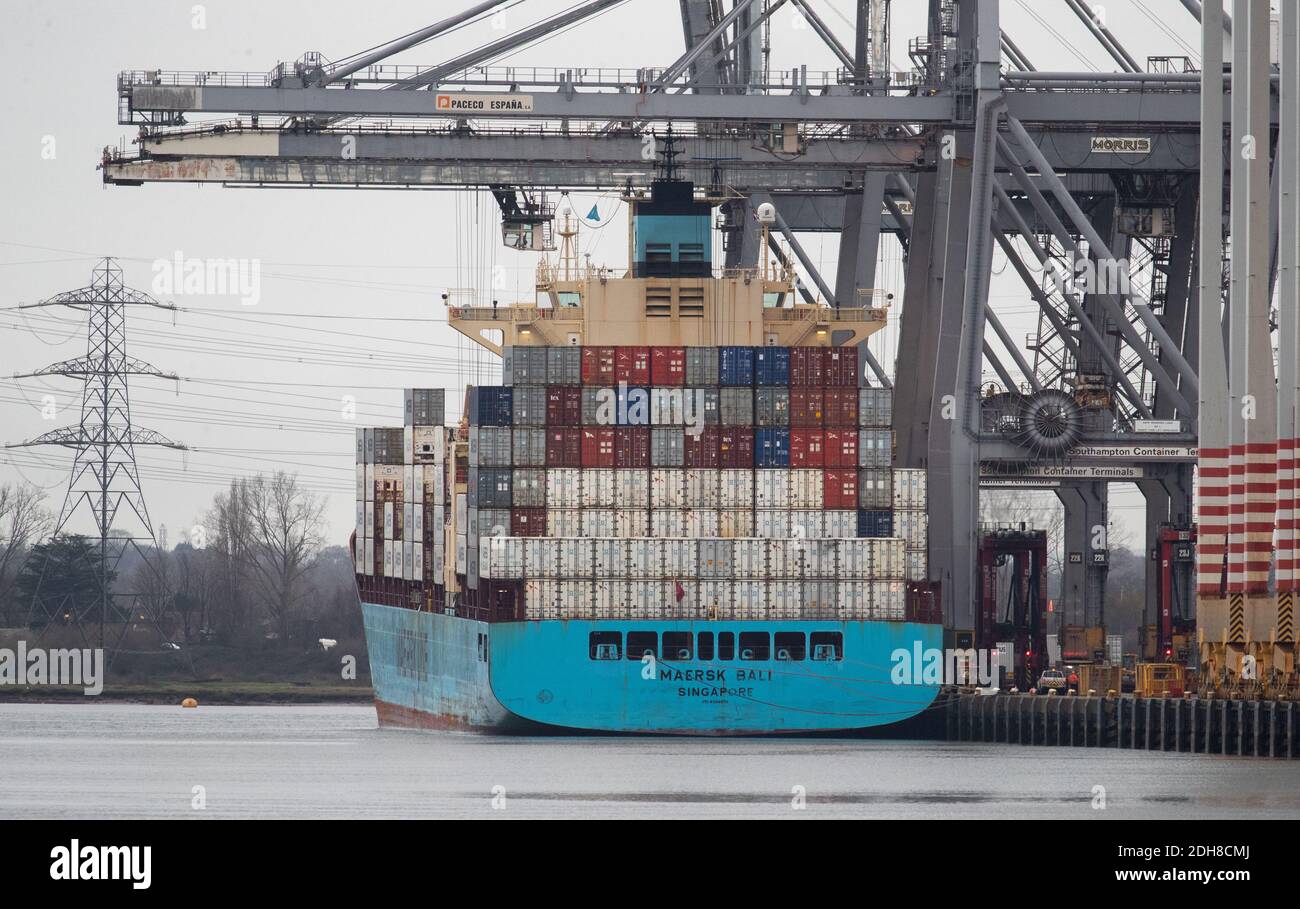 The container ship Maersk Bali has containers unloaded whilst at berth at DP World container terminal in Southampton Docks. Stock Photo