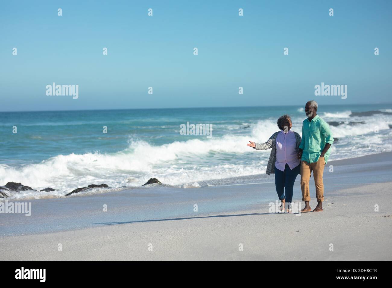 Old couple walking at the beach Stock Photo - Alamy