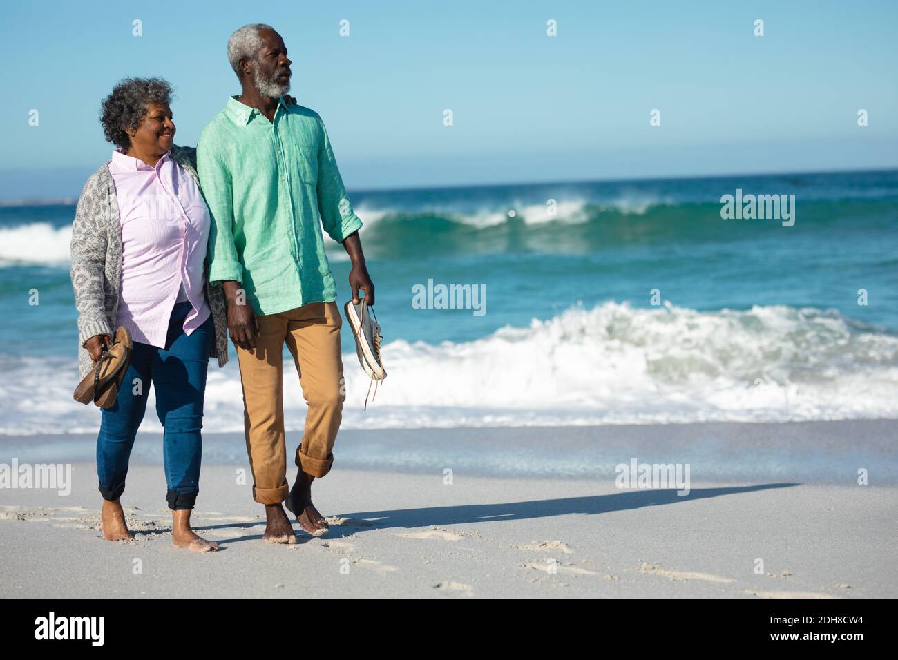 Old couple walking at the beach Stock Photo - Alamy