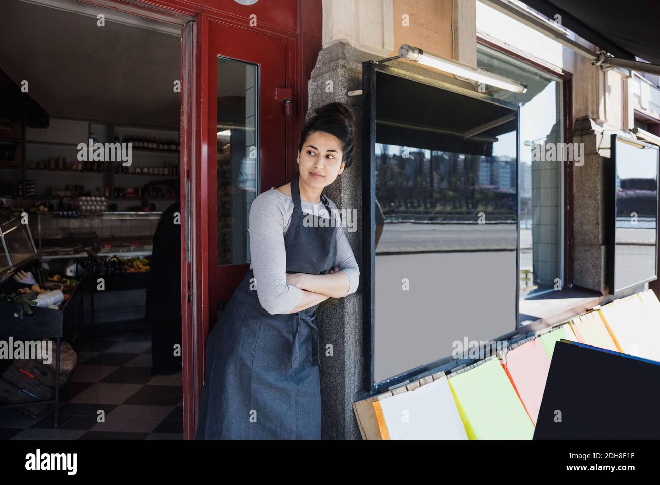Owner wearing apron standing hi-res stock photography and images - Alamy