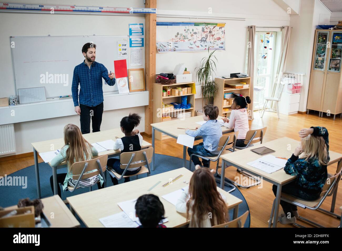 High angle view of teacher teaching students in classroom at school Stock Photo