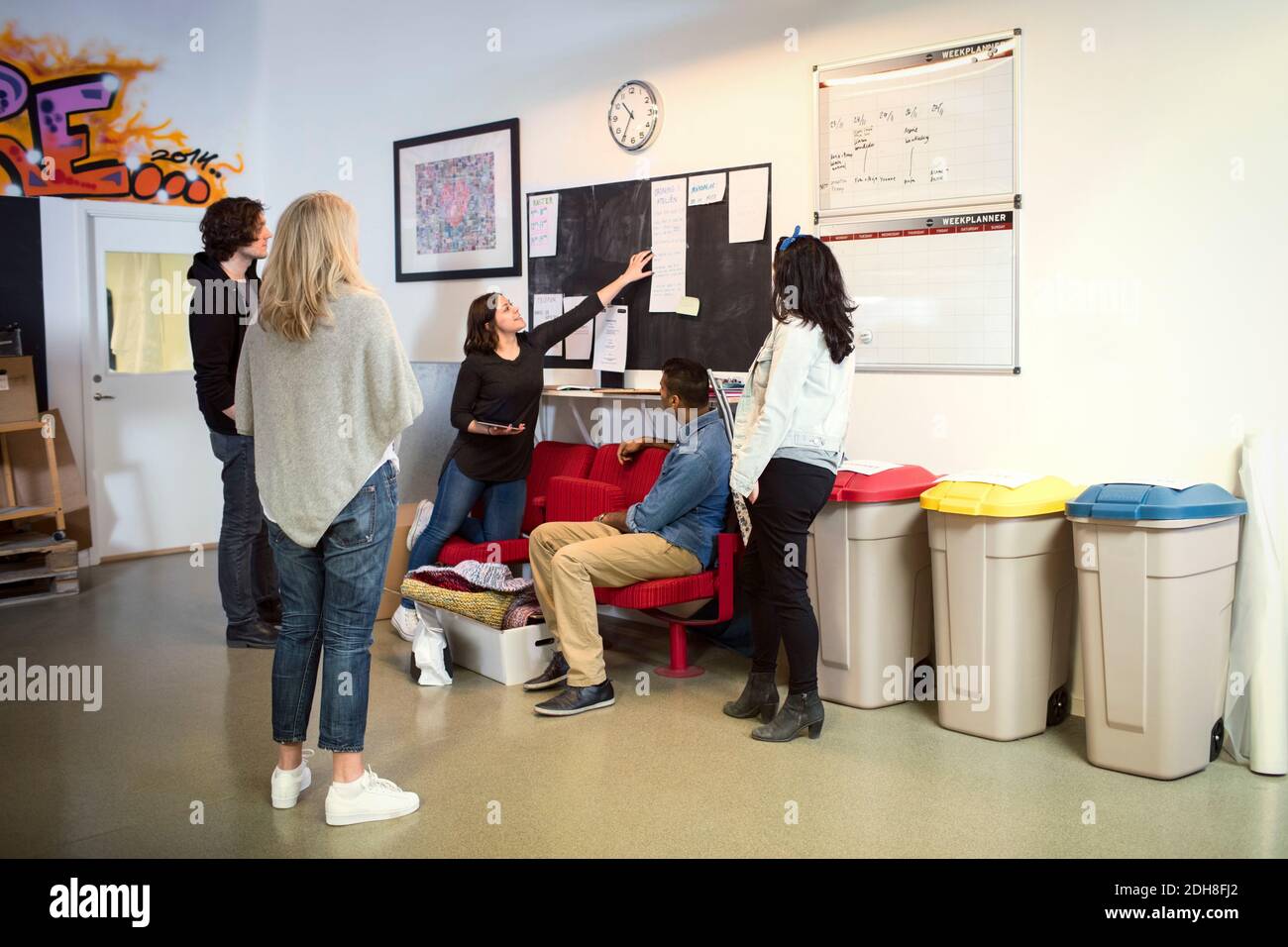 Woman sharing ideas with volunteers in Stock Photo Alamy