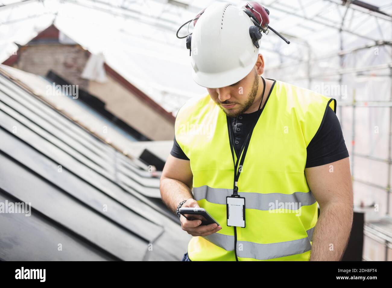 Manual worker using phone while working at construction site Stock ...