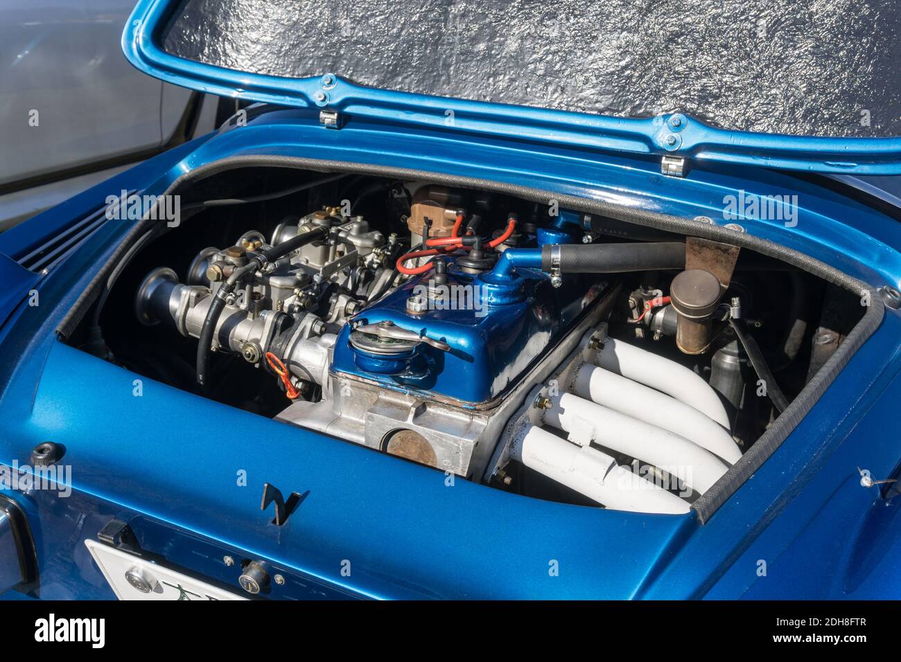 Close up detail of the rear engine and engine bay of a blue 1973 Alpine  A110 1600 Si sports coupe outside in sunshine Stock Photo - Alamy